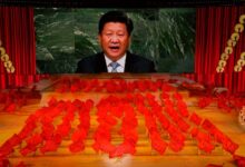 Xi Jinping on a giant screen as performers dance with red flags