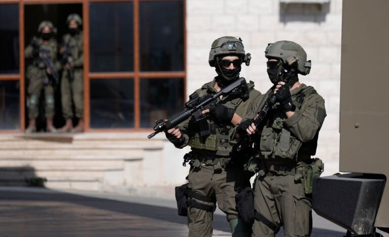 Israeli soldiers search in the West Bank village of Qafin for the suspected gunmen who shot and killed an Israeli civilian near the entrance to a Jewish settlement of Hermesh, Tuesday, May 30, 2023. (AP Photo/Majdi Mohammed)