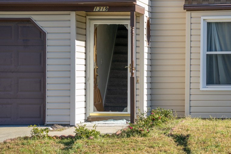 A destroyed door at the house of a suspect in the mass shooting at a Walmart where police served a search warrant in Chesapeake, Va., on Nov. 23, 2022.