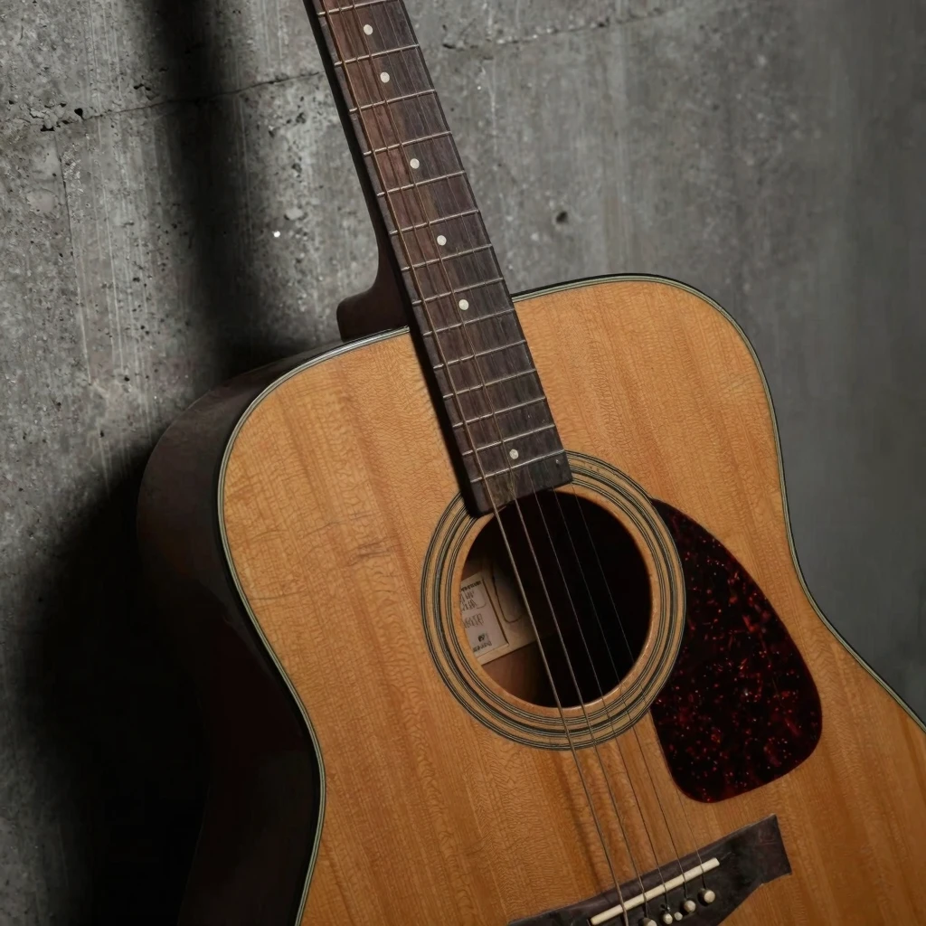 A close-up of an old, worn-out acoustic guitar leaning again...