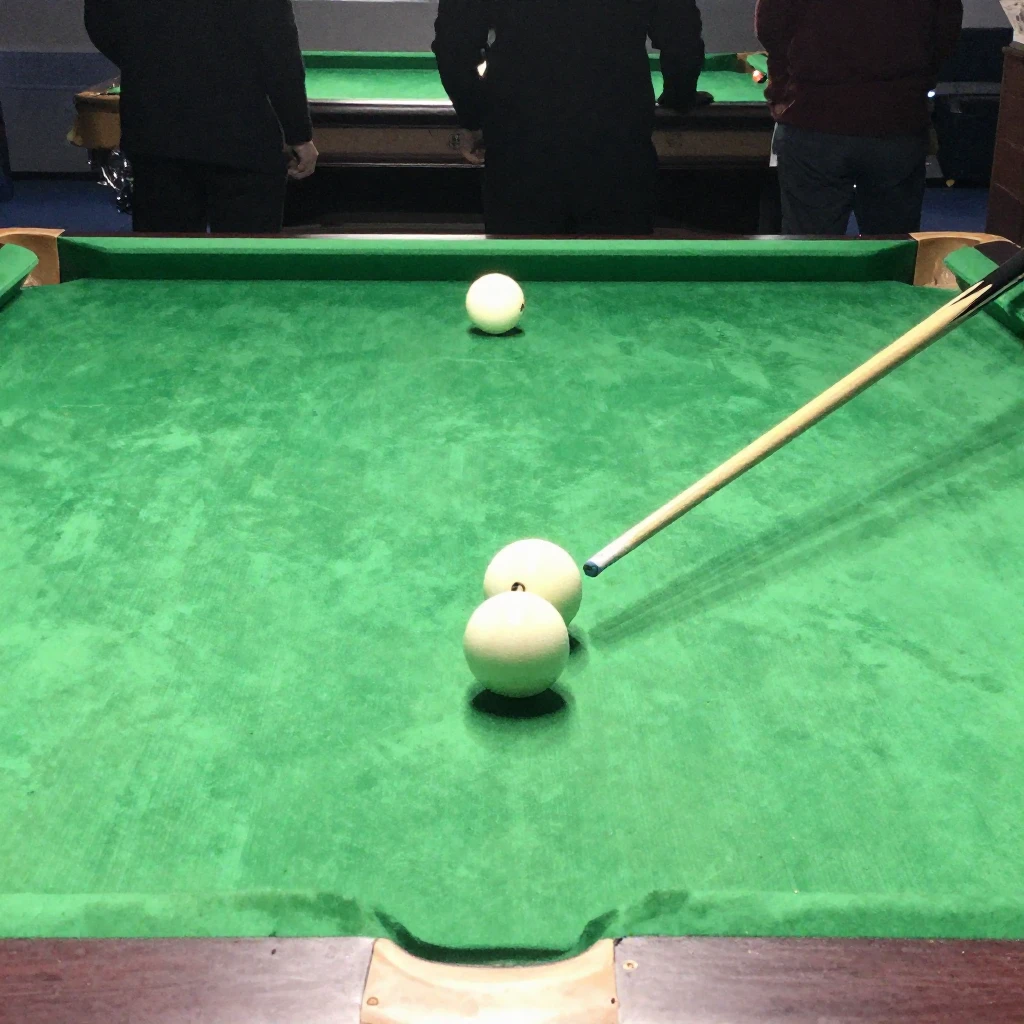 A close-up view of a pool game in progress on a green felt t...