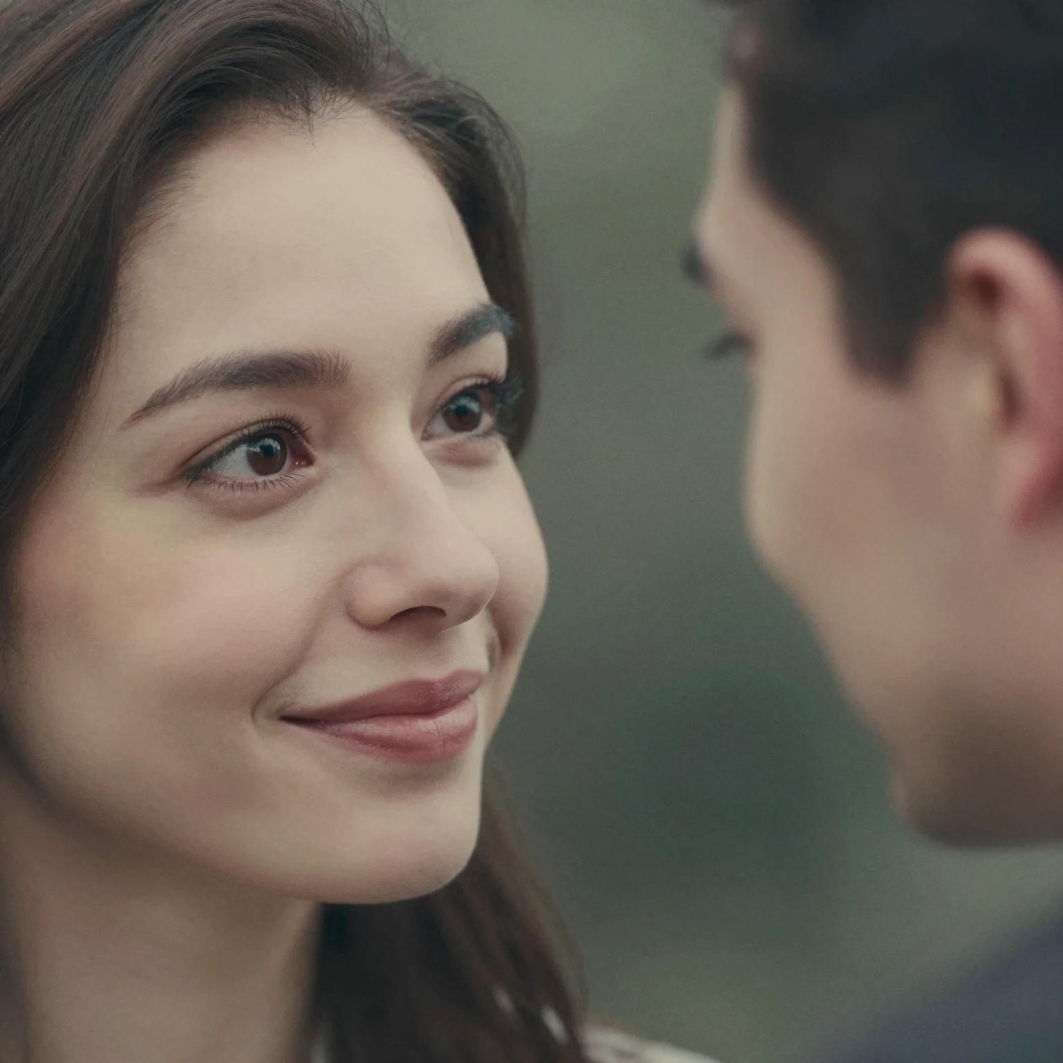 Close-up 16:9 portrait of a woman with European features smi...