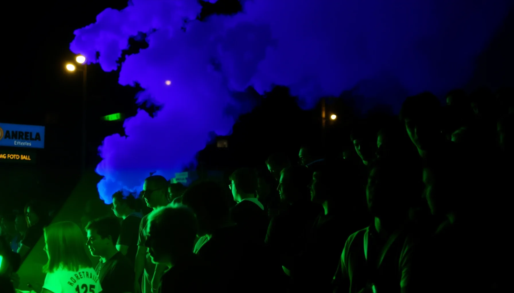 A stylized silhouette of a crowd of football fans in green a...