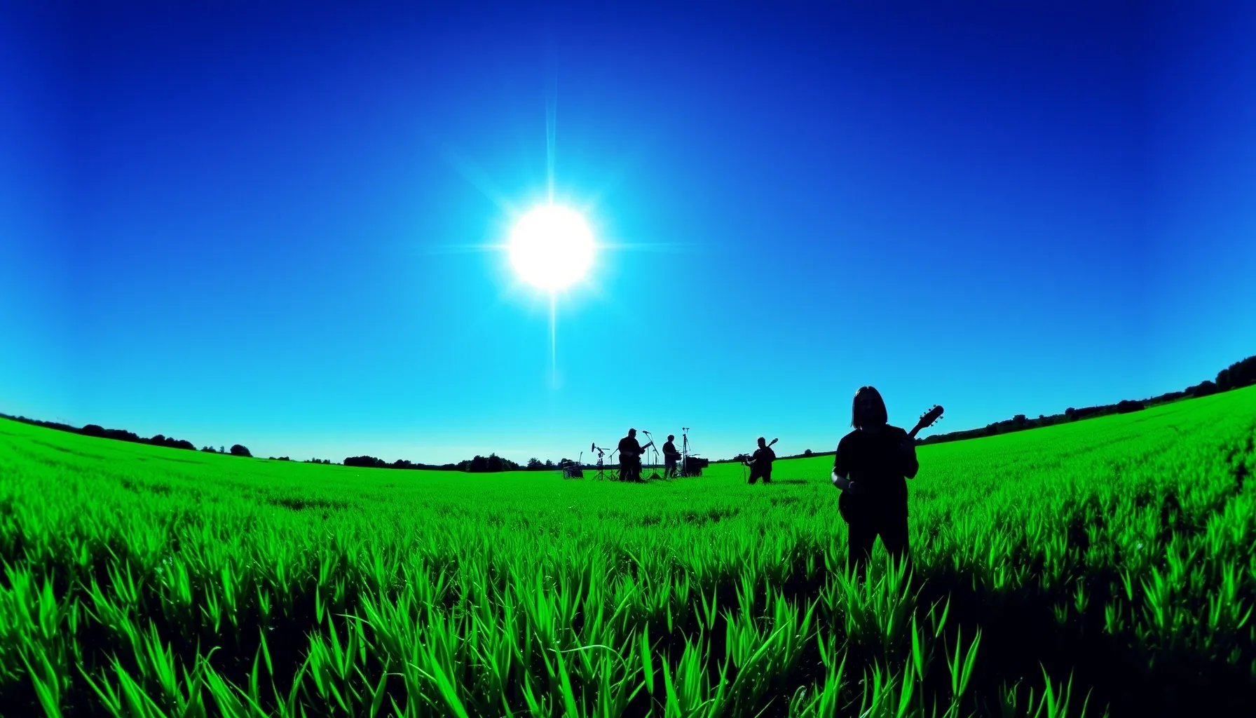 A vibrant green meadow under a blindingly bright sun, but th...