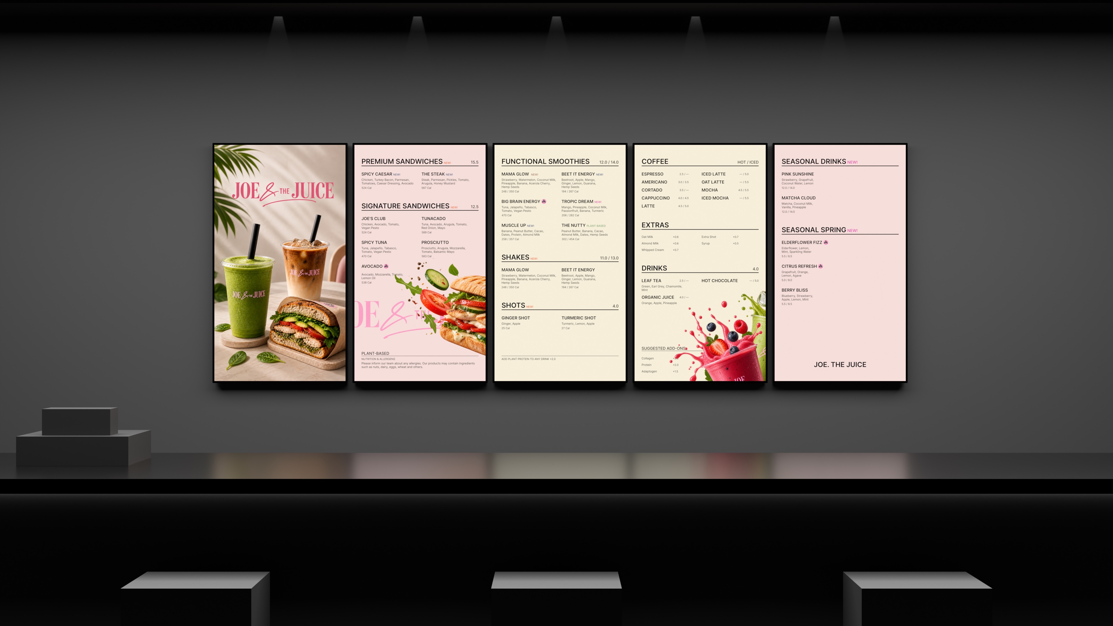 Five-panel wall-mounted digital menu display in a restaurant, showcasing sandwiches, smoothies, coffee, drinks, and seasonal items in a modern interior.