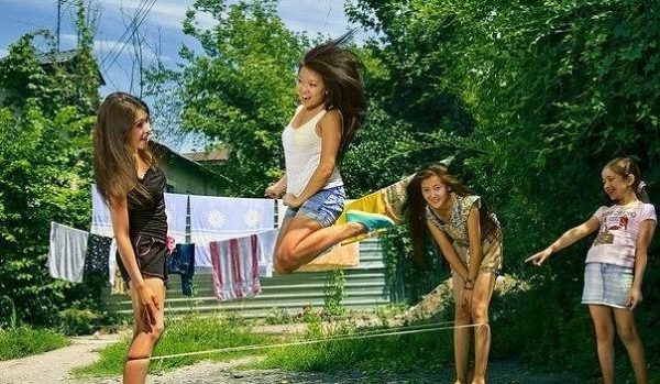 Girls jumping on a rubber band