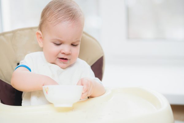 The kid learns to eat himself