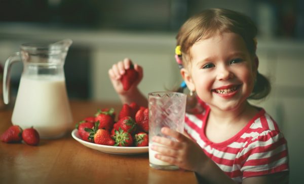 Girl eating strawberries