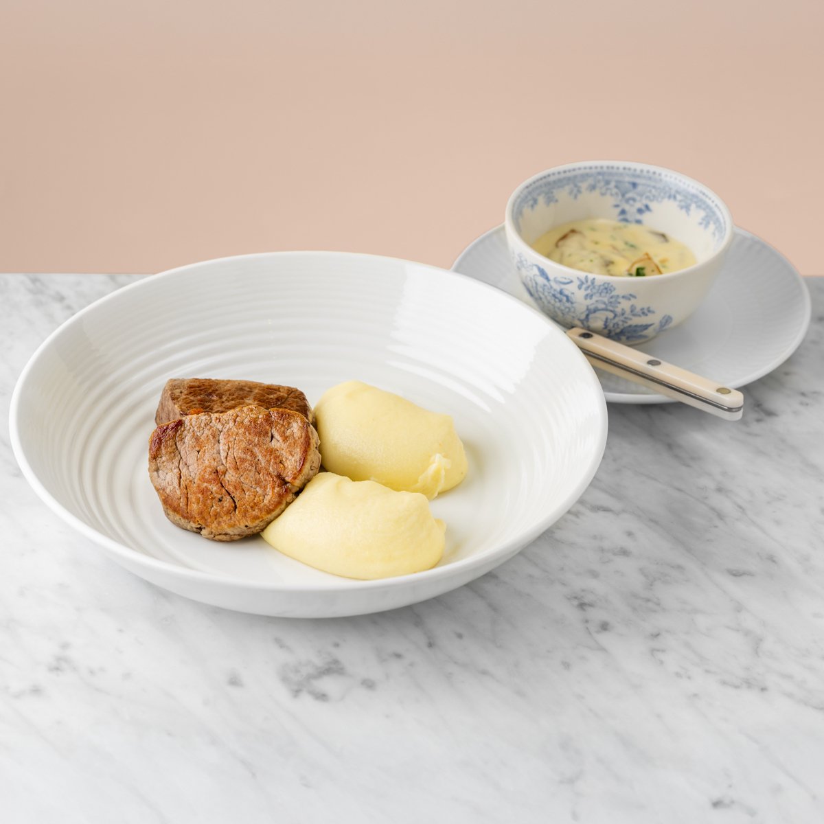 Beef medallions with mashed potato and mushroom sauce