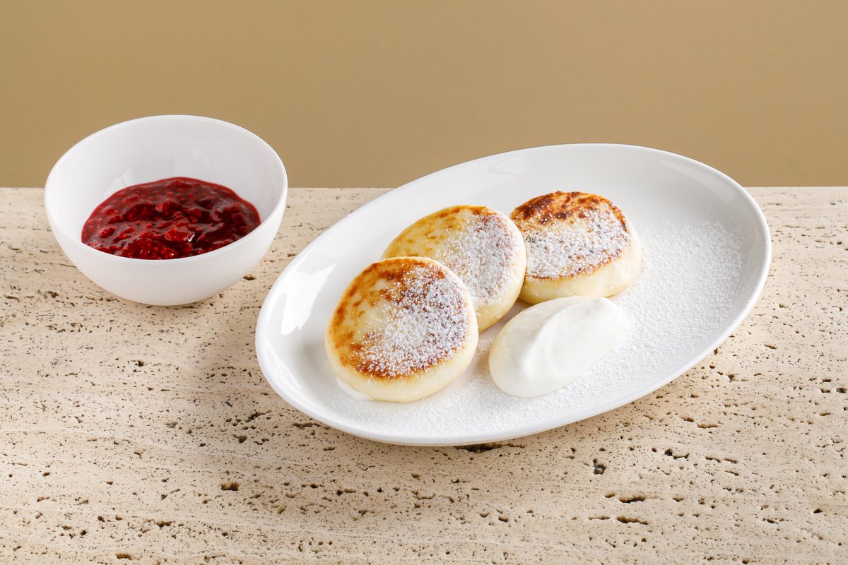 Syrniki with forest berries and sour cream*