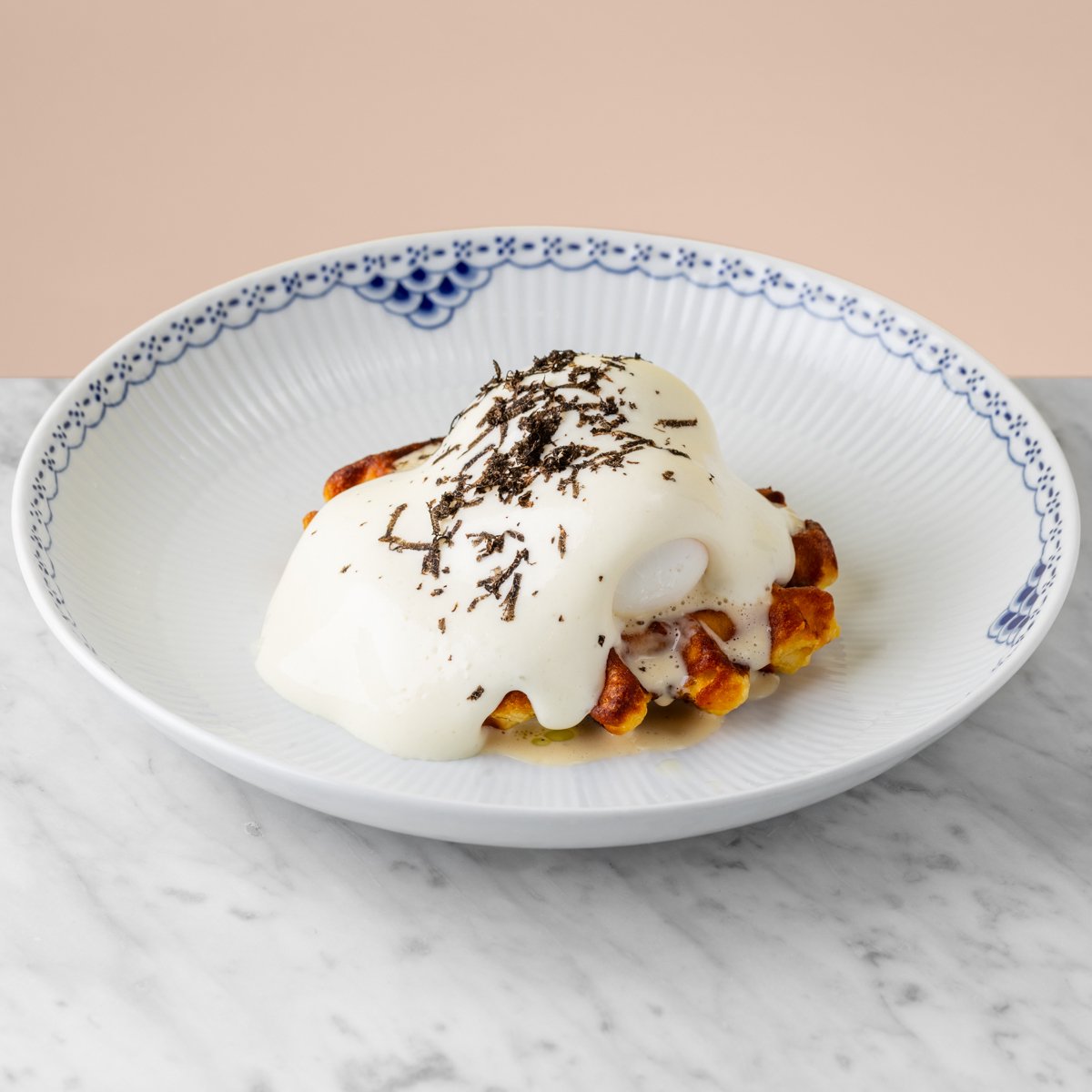 Potato waffle with poached egg and black truffle
