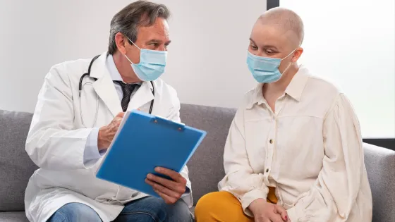 young-woman-suffering-breast-cancer-talking-with-her-doctor-v1