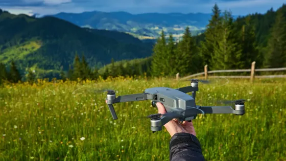 start-drone-launching-from-hands-modern-small-copter-with-camera-user-hand-against-sky-v1