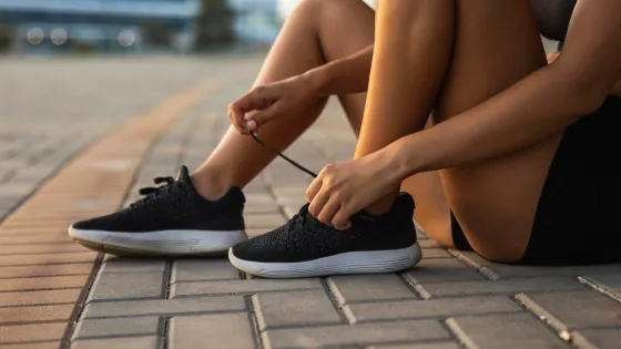 close-up-woman-tying-her-shoelaces