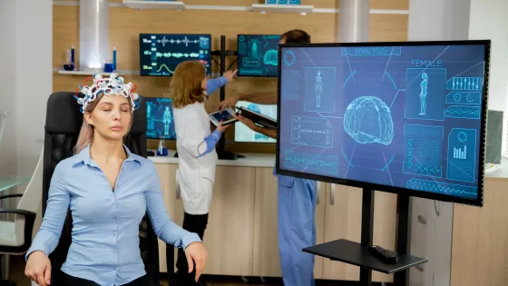 patient-who-is-brain-scanned-his-activity-is-seen-big-screen-neurology-headset