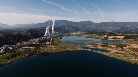 aerial-shot-landscape-surrounded-by-mountains-lakes-with-industrial-disaster-v1