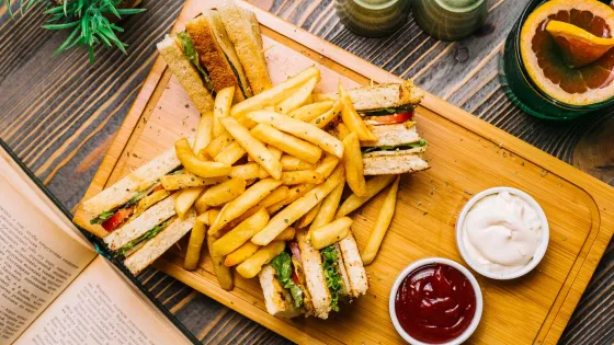 club-sandwich-toast-bread-chicken-tomato-cucumber-french-fries-mayonnaise-ketchup-top-view_141793-2758