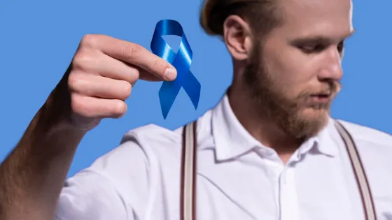 caucasian-man-holding-blue-ribbon_23-2149132226