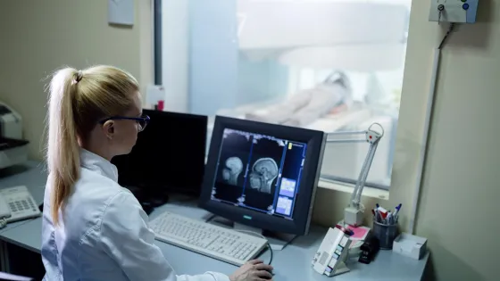 radiologist-analyzing-brain-mri-scan-results-patient-computer-monitor-control-room