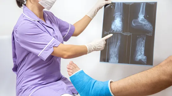 bone-fracture-foot-leg-male-patient-being-examined-by-woman-doctor-hospital