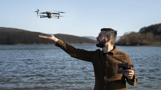 medium-shot-man-with-drone-outdoors