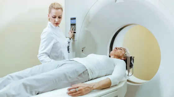 senior-woman-undergoing-mri-scanner-while-doctor-is-supervising-procedure_637285-4576