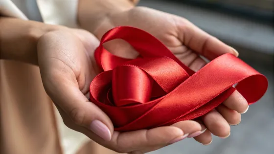 red-satin-ribbon-in-palms-close-up