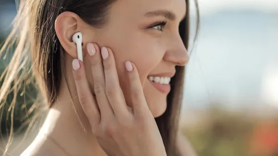 smiling-young-woman-with-headphones-outdoor_624325-1848-v1