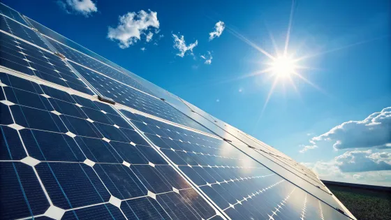 solar-panel-close-up-and-above-it-the-sun-and-blue