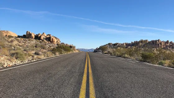 asphalt-road-with-yellow-lines-clear-blue-sky-v1