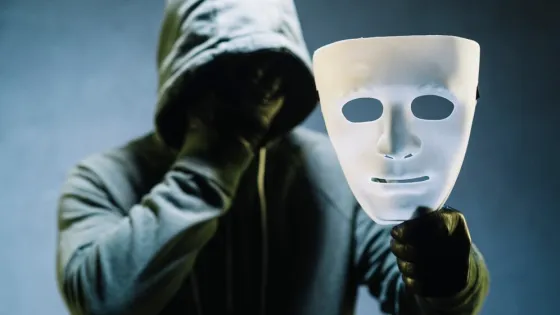hacker-holding-mask_23-2147985365