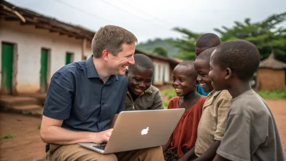 a-white-programmer-with-a-laptop-sits-among-africa