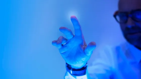 man-touching-futuristic-blue-screen_53876-143029