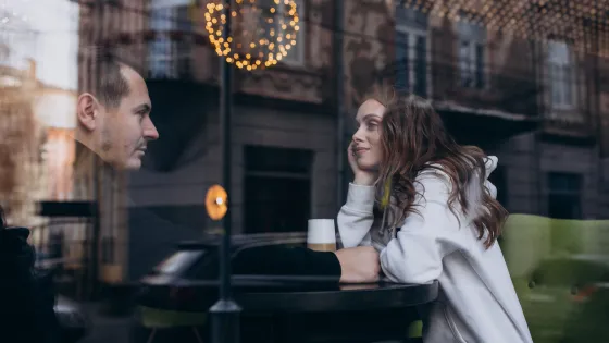 young-couple-sitting-cafe-window-v1