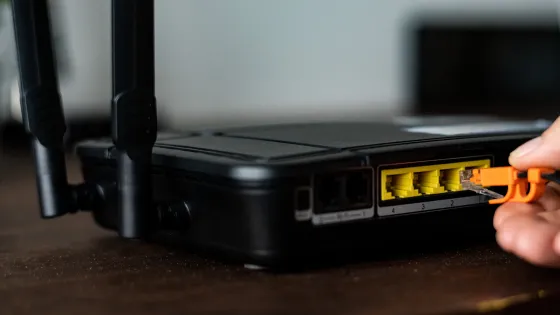 man-plugging-ethernet-cable-wireless-router-v1