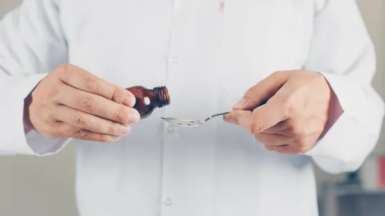 side-view-doctor-pouring-syrup-someone-horizontal