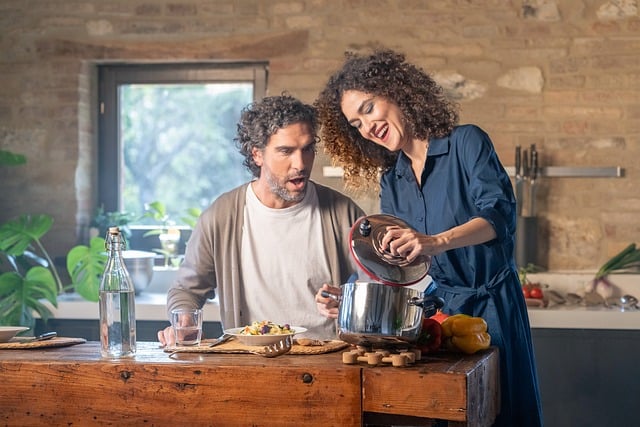 couple, cooking, kitchen, food, home, domestic, relationship, meal preparation, brick wall, lifestyle, happiness, dinner, woman, man, couple cooking, kitchen scene, domestic life, food preparation, healthy eating, homemade, organic, natural light, cozy, warmth