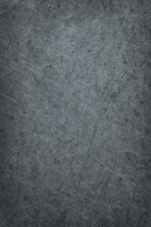 Superficie gris texturizada con rasguños y manchas visuales
