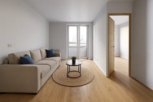 Sala de estar con un sofá y una mesa redonda en tonos nude