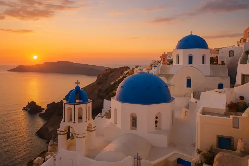 Landscape with blue domes against the backdrop of a sunset and sea in Santorini