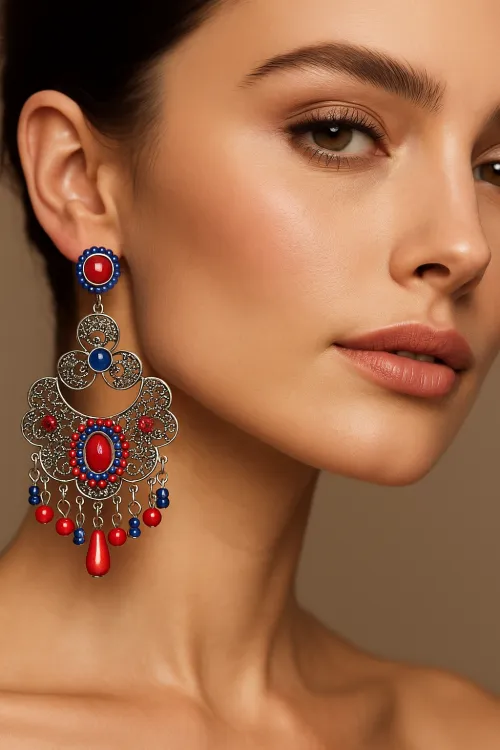 Model with large earrings made of silver metal and colorful stones