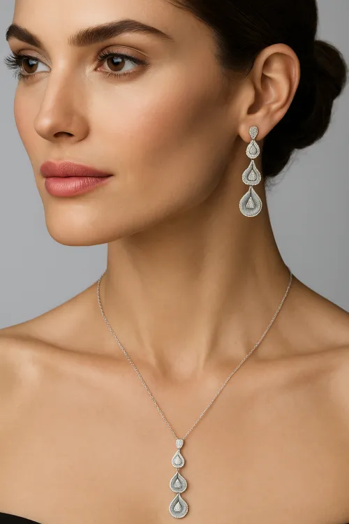 The model showcases exquisite silver earrings and a necklace