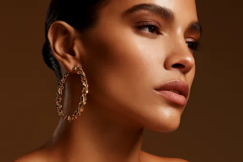 Portrait of a woman wearing gold earrings, soft background