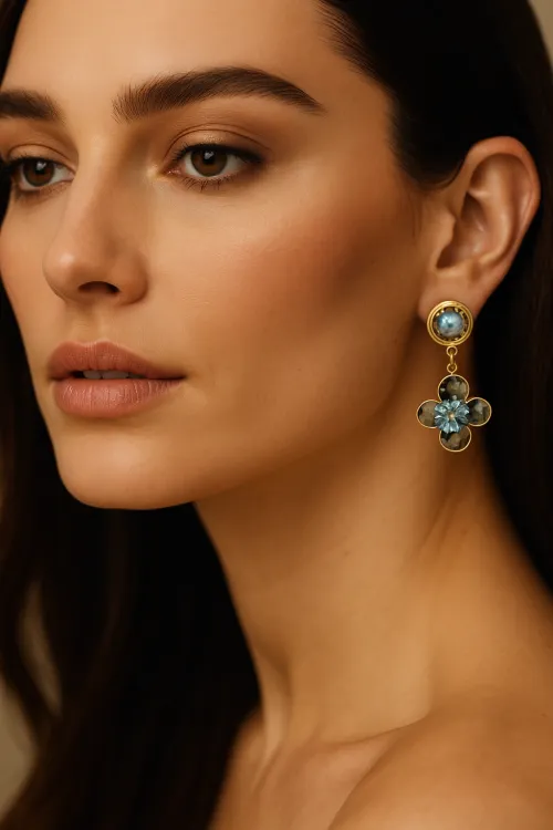 Model with long hair and large flower-shaped earrings
