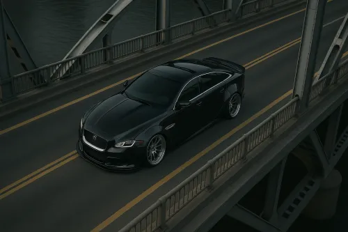 Black car against the backdrop of a bridge and water in the evening