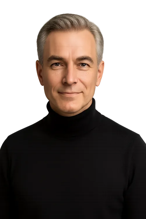 Photo of a Man with Grey Hair in Black Clothing Against a Black Background