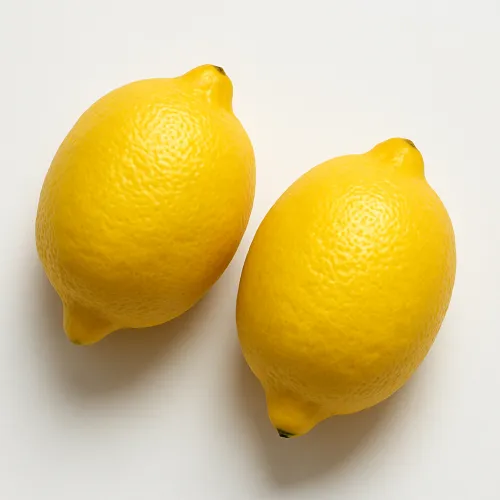 Dos limones sobre un fondo blanco, desde diferentes ángulos