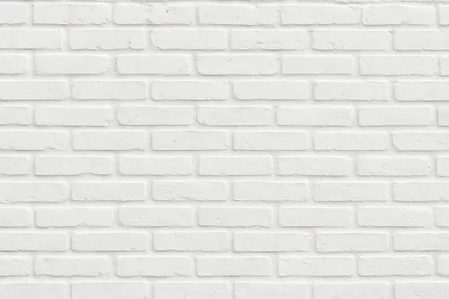 Acercamiento a la pared de ladrillo blanca texturizada en tonos neutros