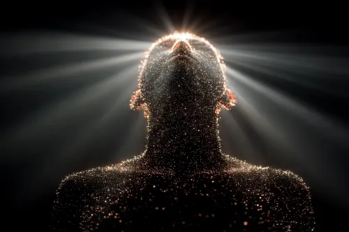 Figure of a person surrounded by glowing particles