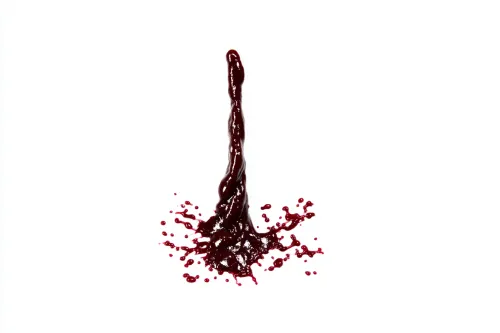 Image of a drop of red substance with splashes on a white background
